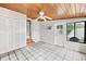 Large sunroom with tile flooring, wood ceiling, access to the outside, and storage at 2105 19Th W St, Bradenton, FL 34205