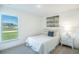 Cozy bedroom with a large window, neutral carpet, and modern decor at 23327 Van Buren Ave, Punta Gorda, FL 33980