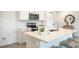 Bright kitchen with a quartz countertop island, stainless steel appliances and modern fixtures at 23440 Avacado Ave, Punta Gorda, FL 33980