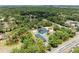 Real estate featuring a bright blue house, detached garage, pool, landscaping, and tree coverage at 2726 Desoto Rd, Sarasota, FL 34234