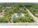 Real estate featuring a bright blue house, detached garage, pool, landscaping, and tree coverage at 2726 Desoto Rd, Sarasota, FL 34234