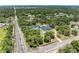 Real estate featuring a bright blue house, detached garage, pool, landscaping, and tree coverage at 2726 Desoto Rd, Sarasota, FL 34234