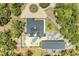Real estate featuring a bright blue house, detached garage, pool, landscaping, and tree coverage at 2726 Desoto Rd, Sarasota, FL 34234