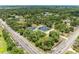 Real estate featuring a bright blue house, detached garage, pool, landscaping, and tree coverage at 2726 Desoto Rd, Sarasota, FL 34234