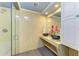 Well-lit bathroom featuring a glass shower enclosure with double bowl sinks at 2726 Desoto Rd, Sarasota, FL 34234