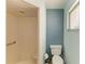Bathroom featuring tiled walk in shower with built in seat and white toilet at 2726 Desoto Rd, Sarasota, FL 34234