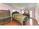 Bedroom boasting pink walls, wood floors, mirrored dresser, and a luxurious bed at 2726 Desoto Rd, Sarasota, FL 34234