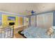 Bright bedroom featuring blue walls, TV, ceiling fan, and tile floors at 2726 Desoto Rd, Sarasota, FL 34234