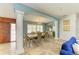 Elegant dining room with tile floors, chandelier, columns, and a large window at 2726 Desoto Rd, Sarasota, FL 34234
