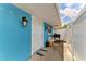 Charming blue home exterior with a white door, quaint lighting, and an outdoor grill area at 2726 Desoto Rd, Sarasota, FL 34234