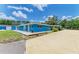 Spacious home with long driveway, blue exterior, tile patio, and well-maintained landscaping at 2726 Desoto Rd, Sarasota, FL 34234