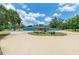 Charming blue house with a circular driveway, a fountain, and beautiful landscaping at 2726 Desoto Rd, Sarasota, FL 34234