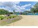 Charming blue house with a circular driveway, a fountain, and beautiful landscaping at 2726 Desoto Rd, Sarasota, FL 34234