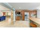 Well-appointed kitchen with stainless steel refrigerator, granite counters, and views of dining and living areas at 2726 Desoto Rd, Sarasota, FL 34234