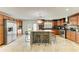 Spacious kitchen featuring a granite island, stainless steel appliances, and wooden cabinetry at 2726 Desoto Rd, Sarasota, FL 34234