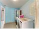 Bright laundry room with large washer and dryer, open doorway, and blue walls at 2726 Desoto Rd, Sarasota, FL 34234