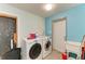 Bright laundry room with large washer and dryer and utility sink at 2726 Desoto Rd, Sarasota, FL 34234
