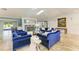 Bright living room with fireplace, skylight, blue furniture, and tiled floors at 2726 Desoto Rd, Sarasota, FL 34234