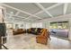 Inviting living room featuring access to the pool area, tile flooring, and coffered ceiling at 2726 Desoto Rd, Sarasota, FL 34234