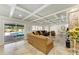 Living room with coffered ceilings, tile floors, and access to the outdoor pool area at 2726 Desoto Rd, Sarasota, FL 34234