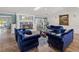 Cozy living room with a fireplace, classic blue seating, and elegant decor at 2726 Desoto Rd, Sarasota, FL 34234