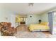 Cozy main bedroom featuring a full bed, sitting area, and kitchenette with bathroom in the background at 2726 Desoto Rd, Sarasota, FL 34234