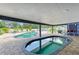 Pool area showcasing an indoor pool, hot tub, brick patio, seating, and grill area at 2726 Desoto Rd, Sarasota, FL 34234