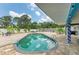 Backyard featuring an outdoor pool, brick patio, seating, and trees at 2726 Desoto Rd, Sarasota, FL 34234