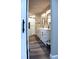 Spacious bathroom featuring double vanity, modern fixtures, glass enclosed shower and wood look flooring at 27944 Green Willow Run, Wesley Chapel, FL 33544