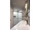 Modern bathroom featuring dual sinks, contemporary fixtures, glass shower and ample lighting at 27944 Green Willow Run, Wesley Chapel, FL 33544
