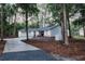 Charming single-story home with a pristine white exterior, three-car garage, and a picturesque wooded lot at 27944 Green Willow Run, Wesley Chapel, FL 33544