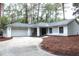 Charming one-story home with a gray roof, inviting curb appeal, and an attached two-car garage at 27944 Green Willow Run, Wesley Chapel, FL 33544