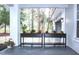 Inviting front porch featuring decorative flower planters with view of wooded scenery at 27944 Green Willow Run, Wesley Chapel, FL 33544