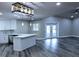Open-concept living space boasting modern lighting, updated kitchen features and views of the backyard at 27944 Green Willow Run, Wesley Chapel, FL 33544