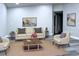 Comfortable living room with neutral tones, plush seating, area rug and contemporary decor at 27944 Green Willow Run, Wesley Chapel, FL 33544