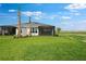 Large grassy yard features the back of this home with a screened in patio at 3204 Torta Ct, Bradenton, FL 34211