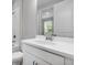 Bathroom vanity features white countertop, cabinet, and a large mirror at 3204 Torta Ct, Bradenton, FL 34211