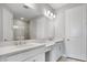 Bathroom with double vanity, a large mirror, modern lighting, and a glass-enclosed shower for a luxurious experience at 3204 Torta Ct, Bradenton, FL 34211