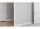 Hallway featuring hardwood floors, neutral paint and white doors, offering access to different rooms in the home at 3204 Torta Ct, Bradenton, FL 34211