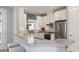 Bright kitchen featuring stainless steel appliances, white cabinetry, and a breakfast bar with seating at 3204 Torta Ct, Bradenton, FL 34211