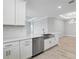 Bright kitchen with stainless steel appliances, white cabinets, tile floors, and a modern sink at 3204 Torta Ct, Bradenton, FL 34211