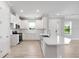 Bright kitchen with stainless steel appliances, white cabinets, and an island with bar seating at 3204 Torta Ct, Bradenton, FL 34211