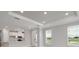 Open-concept living room showcases recessed lighting, large windows, and a modern kitchen with a breakfast bar at 3204 Torta Ct, Bradenton, FL 34211