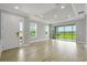 Bright living room with tile floors, recessed lighting, and sliding glass doors to the backyard at 3204 Torta Ct, Bradenton, FL 34211