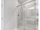 Modern shower featuring glass doors, tiled walls and a shower head, creating a spa-like experience at 3204 Torta Ct, Bradenton, FL 34211