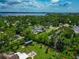 An aerial view showcases lush greenery and the tranquil waterfront, highlighting a serene residential neighborhood at 326 25Th W St, Bradenton, FL 34205