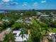 Aerial view highlighting a neighborhood home surrounded by mature trees and lush landscaping at 326 25Th W St, Bradenton, FL 34205