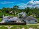 Aerial view of home with fence and carport with a truck, surrounded by trees, providing a private backyard at 326 25Th W St, Bradenton, FL 34205