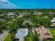 The aerial shot shows a residential neighborhood with lush greenery surrounding well-kept homes at 326 25Th W St, Bradenton, FL 34205