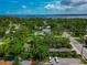 Beautiful aerial view of a lush, green neighborhood with glimpses of the serene waterfront in the distance at 326 25Th W St, Bradenton, FL 34205